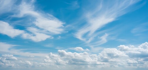 Beautiful blue sky with puffy and wispy clouds offering a calm and serene atmosphere