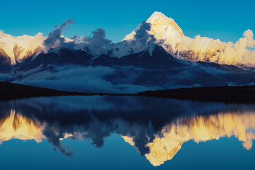 Serene Reflection of Snowy Mountains by the Lake