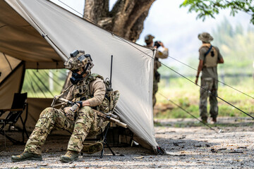 Elite Special Forces Soldier in Tactical Gear Preparing Weapon – Combat Mission Readiness Near...