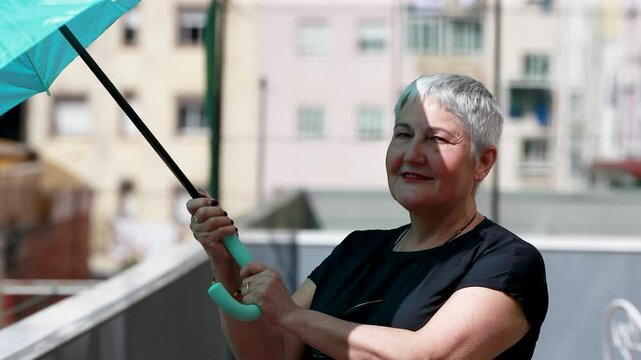 senior woman with umbrella protecting herself from the sun during a heat wave
