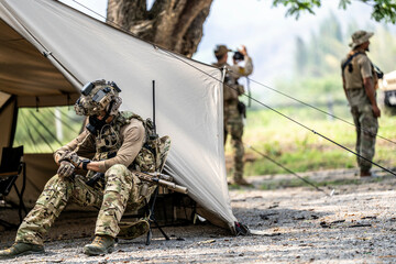 Elite Special Forces Soldier in Tactical Gear Preparing Weapon – Combat Mission Readiness Near...