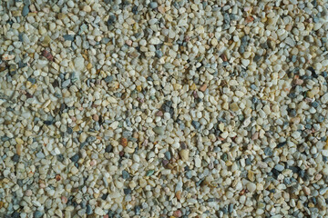 Pebble background. Beautiful creative natural background with visible little pebbles texture and rough uniform structure. Pebbles on the ground. Rough texture, construction material background