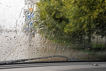 rain and tornado while driving on the road on the windshield. natural disaster