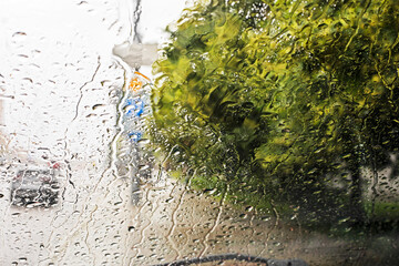 rain and tornado while driving on the road on the windshield. natural disaster