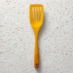 Wooden Cooking Spatula on Textured White Background with Shadows