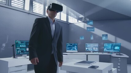 Businessman wearing VR headset in office. Technology used in workplace. Man explores data in VR. Office environment with digital devices. Virtual interface in business. Work with new virtual tools - Powered by Adobe
