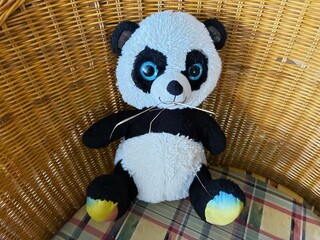 Plush panda eating straw.