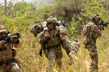 Soldier Carrying Injured Comrade During Tactical Combat Mission – Military Rescue Operation in...