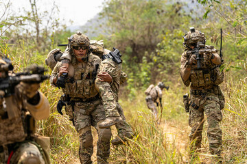 Soldier Carrying Injured Comrade During Tactical Combat Mission – Military Rescue Operation in...