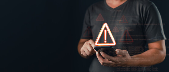 A person using a smartphone is surrounded by glowing warning icons and code overlays, symbolizing caution in cybersecurity, digital threat detection, and the importance of mobile data protection.