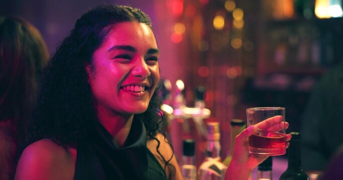 Woman, smile and talk with drink at nightclub with celebration, party and social event at bar. Friends, girl and discussion with whiskey, alcohol and excited with beverage for new years eve at pub