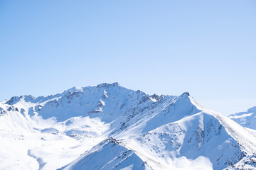 View of winter mountain peaks and glaciers from the top of Kumbel peak not far from Almaty.