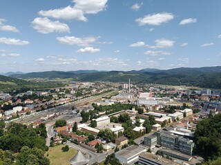 A panoramic view of trencin slovakia featuring its historic cityscape, river, and surrounding hills under a blue sky, concept of european tourism, urban landscape, historical architecture