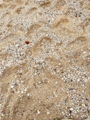 Textured natural brown granite stone wall with a rough, abstract rock pattern