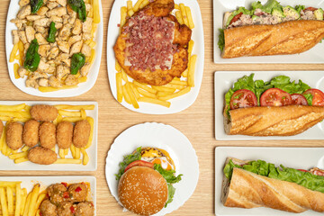 Delicious spanish food showcasing diverse dishes including french fries, sandwiches, a burger, and local specialties