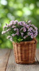 A wicker basket brimming with colorful wild flowers is beautifully displayed on a table, surrounded by a serene green bokeh backdrop