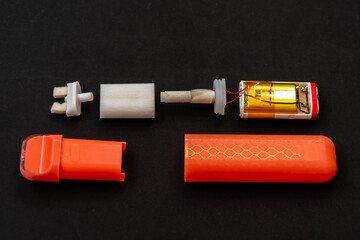 Electronic vape in detail on black background - chip, wiring, filter and mouthpiece.