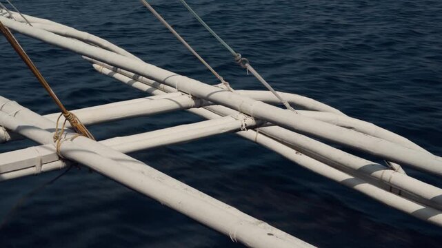 Close-Up of wooden Bangka Outriggers boat in Motion in blue water Sea in Philippines