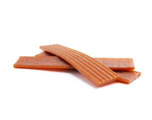 Pieces of delicious fruit leather on white background