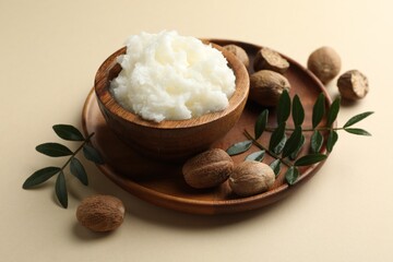 Natural shea butter on beige background, closeup