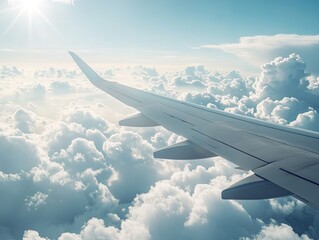 Obraz premium Airplane wing over fluffy clouds (1)