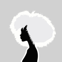 Profile of woman with afro and light background halo

