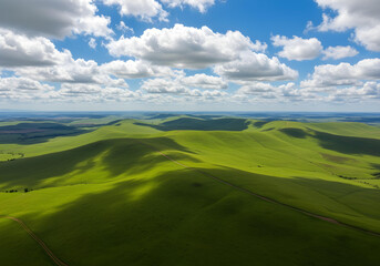 Obraz premium rolling green hills under dramatic cloudy blue sky landscape 