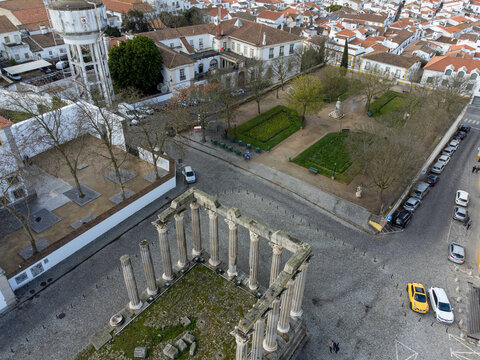 Aerial view of Jardim Diana in &Eacute;vora, Portugal, with Roman Temple ruins and historic architecture surrounded by green trees and cobbled streets.