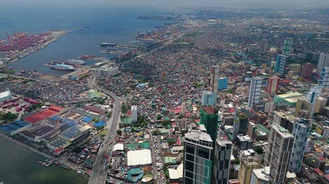 180 Drone view of the entire Baseco Port, Binondo and Intramuros historic walled district with its churches, old buildings, and manicured greenery surrounded by modern Manila &ndash; Manila, Philippines