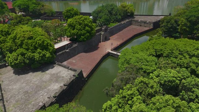 Aerial view of Fort Santiago&rsquo;s stone walls and lush gardens beside the Pasig River with Manila's modern cityscape in the background &ndash; Intramuros, Manila, Philippines