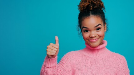 a nice young woman showing her thumb up wearing a pink sweater isolated on a solid blue colour background, bright colours, studio lighting, copy space