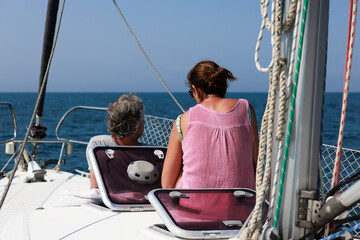 Mature couple enjoying relaxing sailboat trip in Costa Brava, Spain