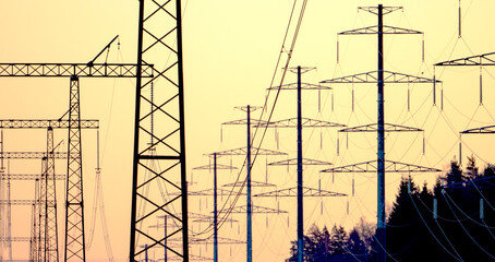 High-voltage power lines in the background of sunset or dawn