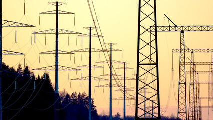 High-voltage power lines in the background of sunset or dawn