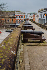 Historic cannons are positioned atop the ancient Londonderry City Walls, offering a glimpse into...