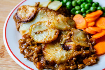 Traditional British Favourite Beef Hotpot With Carrots and Peas
