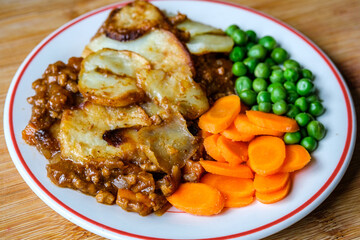 Traditional British Favourite Beef Hotpot With Carrots and Peas