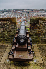 Historic cannons are positioned atop the ancient Londonderry City Walls, offering a glimpse into...