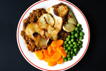 Traditional British Favourite Beef Hotpot With Carrots and Peas