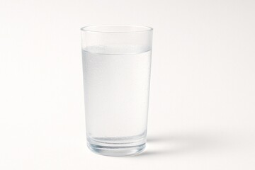 Glass of fresh mountain spring mineral water with condensation and natural light on white background