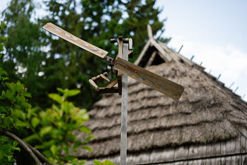 Wooden propeller on a pole with a rustic background and nature