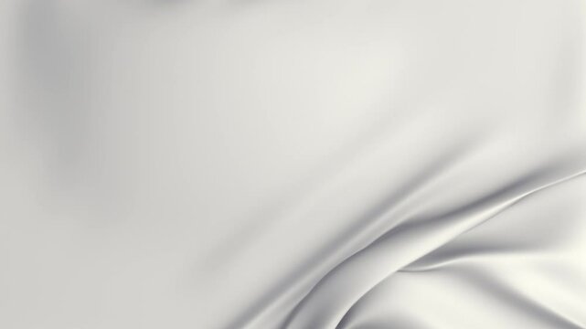 Two transition clips of black, white cloth gently falling onto a flat surface before being softly pulled away from the side of the frame to reveal a green-screen.