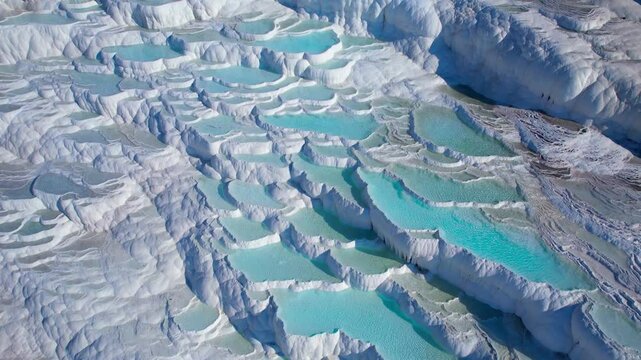 Pamukkale Turkish, Natural travertine pools terraces with blue water, aerial top view.