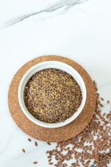 Ground and whole flax seeds on white background. Flat lay. Copy space.