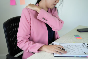 Pain body muscles stiff problem, an asian young woman is having the hand and neck pain from work...