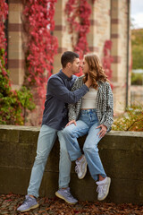 Young Cute Female Hugs Boyfriend. In Autumn Outdoor. Lovers Walking in Park. Attractive Funny Couple. Lovestory in Forest. Man and Woman. Cute Lovers in the Park. Family Concept. Happy Couple.