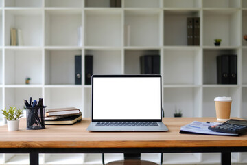 White office desk with laptop and modern office equipment