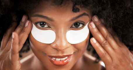 Skincare, eye mask and portrait of black woman for facial care, dark circles and wellness. Dermatology, closeup and face of person with collagen pads for beauty, anti aging and cosmetics for health © Pixi/peopleimages.com
