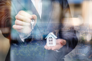 Holding keys to a new home in a bustling city
