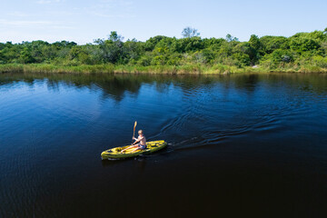 Happy active kids have a fun on yellow kayak in sea lagoon.  Healthy lifestyle. Recreational water sport, kayaking tour in adventure camp on family summer beach vacation